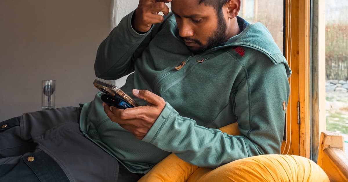Man looking at his phone with a puzzled expression